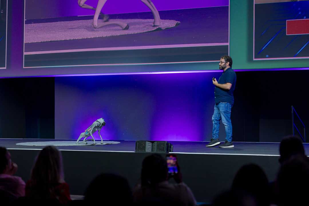 Benjamin Rosman demonstrating a quadruped robot on stage at the Singularity South Africa Summit
